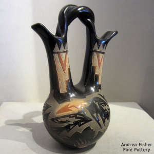 Sgraffito avanyu and geometric design on a black wedding vase with sienna spots and a twisted handle