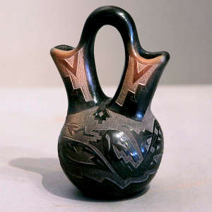 Sgraffito avanyu design and sienna detailing on a black wedding vase