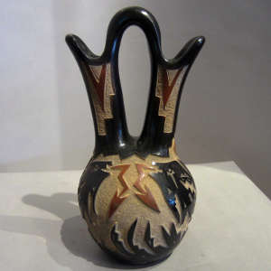 Sgraffito designs and sienna spots on a black wedding vase