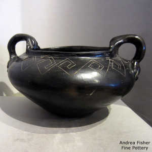 Black water jar polished inside and with hand-shaped handles and a sgraffito geometric design