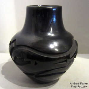 Avanyu design carved into a polished black jar