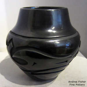 Avanyu design carved into a black jar