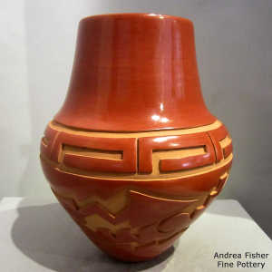 Avanyu design carved into a red jar