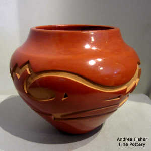 Avanyu design carved into a red jar