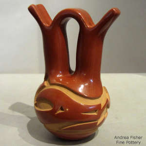 Avanyu design carved into a red wedding vase