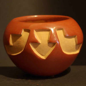 Kiva step and arrow design carved into a red jar