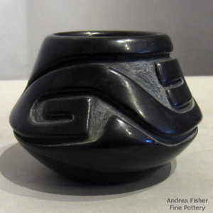 Geometric design carved into a black jar