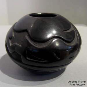 Avanyu design carved into a black jar