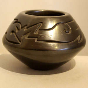 Avanyu design carved into a polished black jar