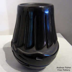 Feather and avanyu design carved into a black jar