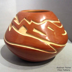 Avanyu design carved into a red jar