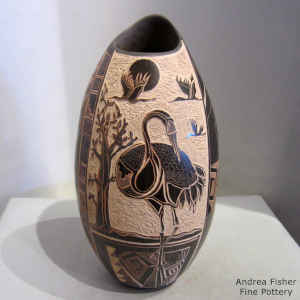 Sgraffito crane, tree, fine line and geometric design on a sienna jar with an organic opening