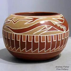 An avanyu and feather design on a polychrome bowl