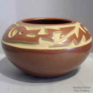 Red bowl carved with an avanyu design