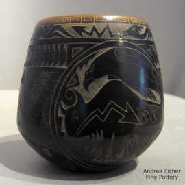 A sgraffito wildlife, nature, medallion, feather, bison, eagle, avanyu and geometric design on a small black jar with a sienna rim