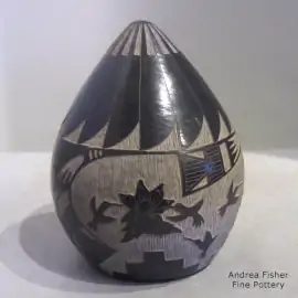 Sgraffito feather, bird, flower and geometric design on a black seed pot