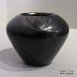 Bear paw imprints on a black jar