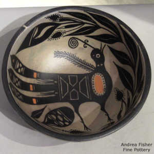Turkey and plant design inside, geometric design outside on a polychrome bowl