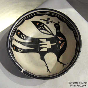 Bird design inside and geometric design outside a polychrome bowl
