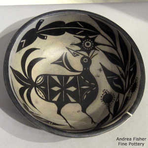 Bird and flower design inside and geometric design outside on a polychrome bowl