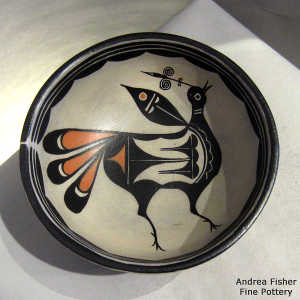 Geometric design outside and bird design inside a polychrome bowl