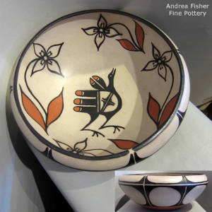 Bird and floral design inside a large polychrome bowl with a geometric design on the outside
