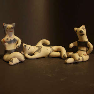 Bathing suits on three lounging pigs