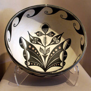 Cotton plant and water design inside with water design outside on a large polychrome bowl