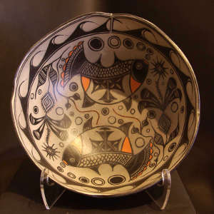 Fish, flowers, water and geometric designs on a polychrome bowl