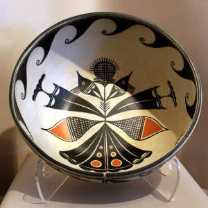 Cloud, flower and wave design inside and geometric design outside on a polychrome bowl