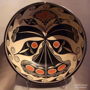 Cotton flower and geometric design inside with geometric design outside on a polychrome dough bowl