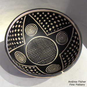 Spiral, star and geometric design inside and out on a polychrome bowl