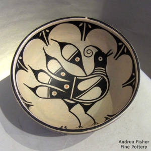 Black and white bowl with bird and geometric design inside and out