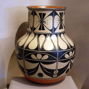 Black and white butterfly and geometric designs on a polychrome jar