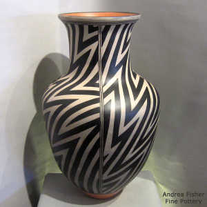 Black and white lightning bolt and geometric design on a polychrome jar