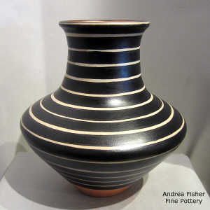 Black and white geometric design on a low shoulder, high neck polychrome jar