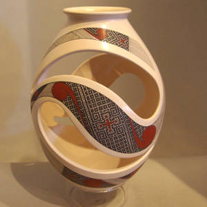 White jar with geometric (yin/yang) cutouts plus red and black geometric designs, Click for a larger version Red and black geometric designs on a white jar with geometric cutouts