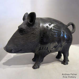 Black on black javelina with carved head and legs and Paquime designs on the body, Click for a larger version Carved head and legs and Paquime designs on the body of a black on black javelina