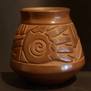 Brown jar carved with spiral, feather, hand and geometric designs, Click to see a larger version Spiral, feather, hand and geometric designs carved into a brown jar