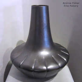 A melon base on a micaceous black jar with fire clouds