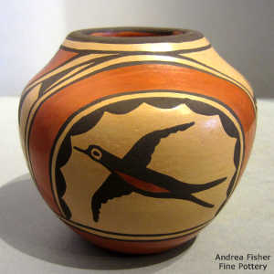 Bird, rainbow and geometric design on a polychrome jar