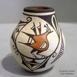 Bird, flute player and geometric design on a polychrome jar