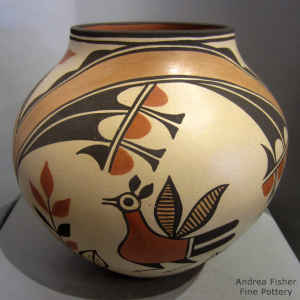 Bird, flower, rainbow, medallion and geometric design on a polychrome jar