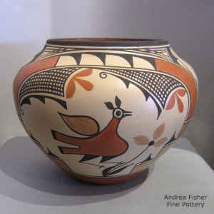 Rainbow, roadrunner, flower and geometric design on a polychrome jar
