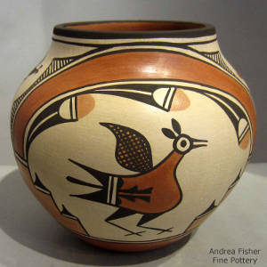 Bird, rainbow, cloud and geometric design painted on a polychrome jar