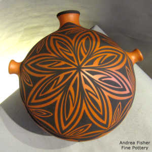 Rosette, deer, heart line and geometric design on a polychrome canteen