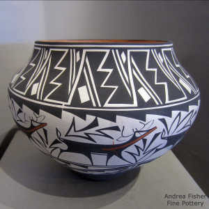 Deer, heart line, lightning bolt and geometric design on a polychrome jar