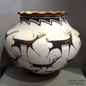 Deer, heart line and geometric design on a polychrome jar with a pie crust rim