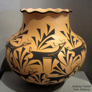 Deer, heart line and geometric design on a polychrome jar with a pie crust rim