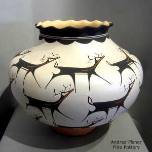 Deer, heart line and geometric design on a polychrome jar with a pie crust rim